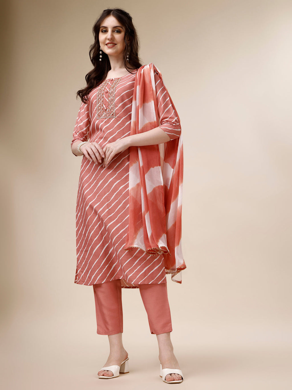A woman wearing a vibrant multicolor embroidered Leheriya kurta with matching pant and dupatta set.