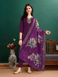 A woman wearing a vibrant multicolor hand embroidered rayon kurta set with an organza printed dupatta.