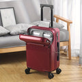 Modern hard shell carry-on spinner suitcase with diagonal ribbing and front laptop access pocket