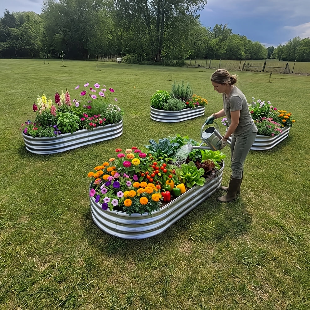A 4x2x1ft oval galvanized steel raised garden bed planter box on a patio
