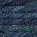 Skein of deep navy and teal Silky Merino yarn with a soft, lustrous sheen