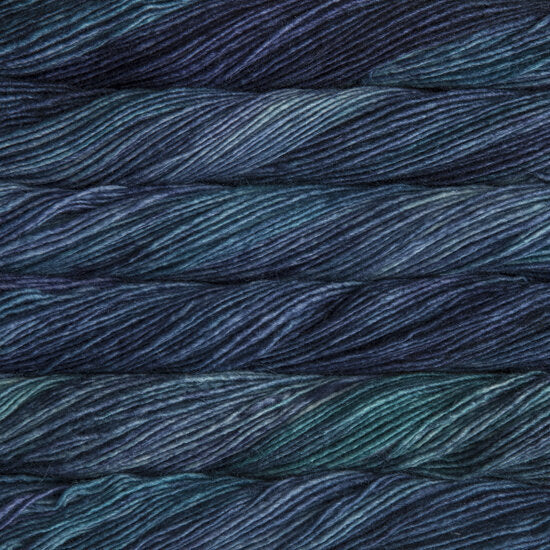 Skein of deep navy and teal Silky Merino yarn with a soft, lustrous sheen
