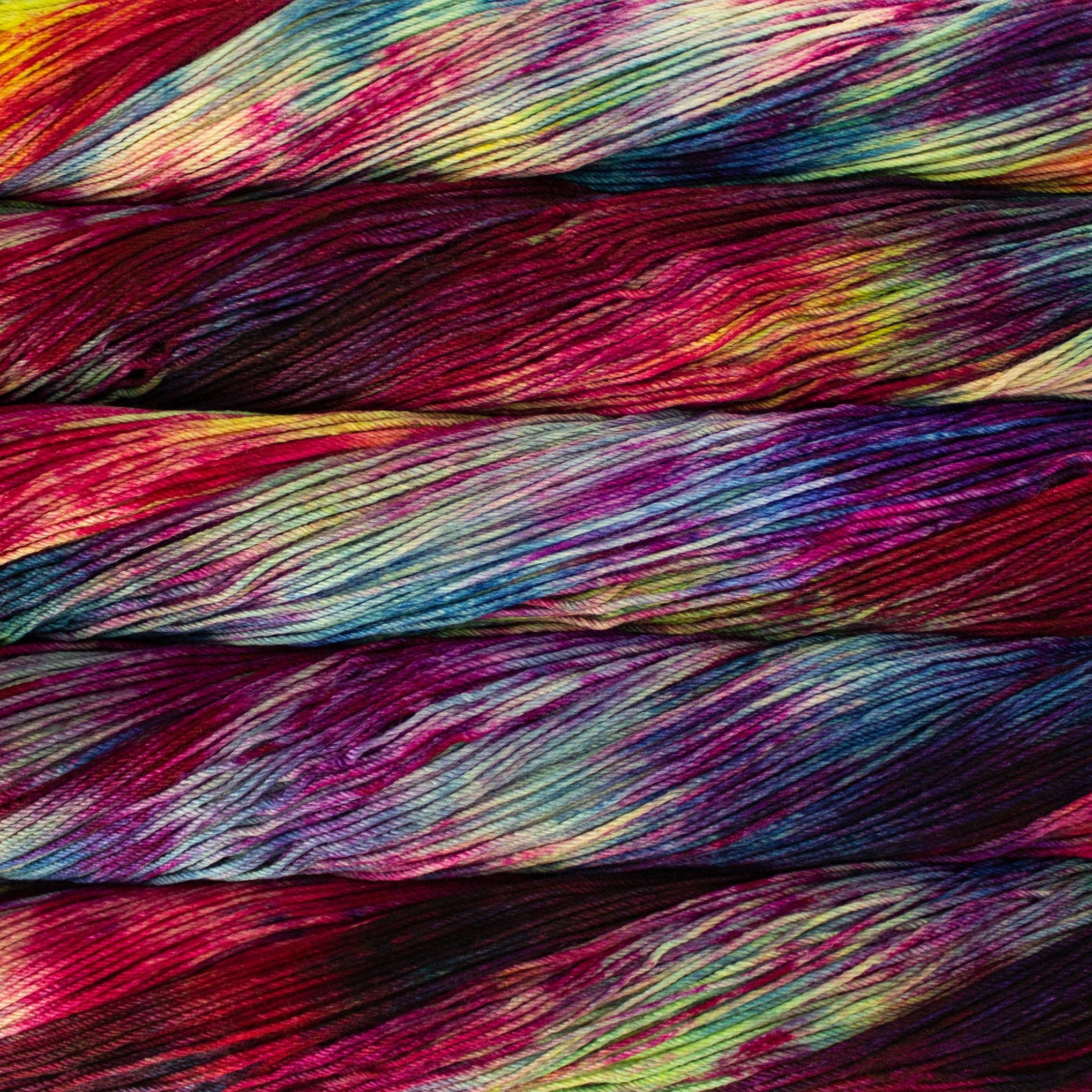 Skeins of Malabrigo Arroyo yarn in rich, hand-dyed colors.