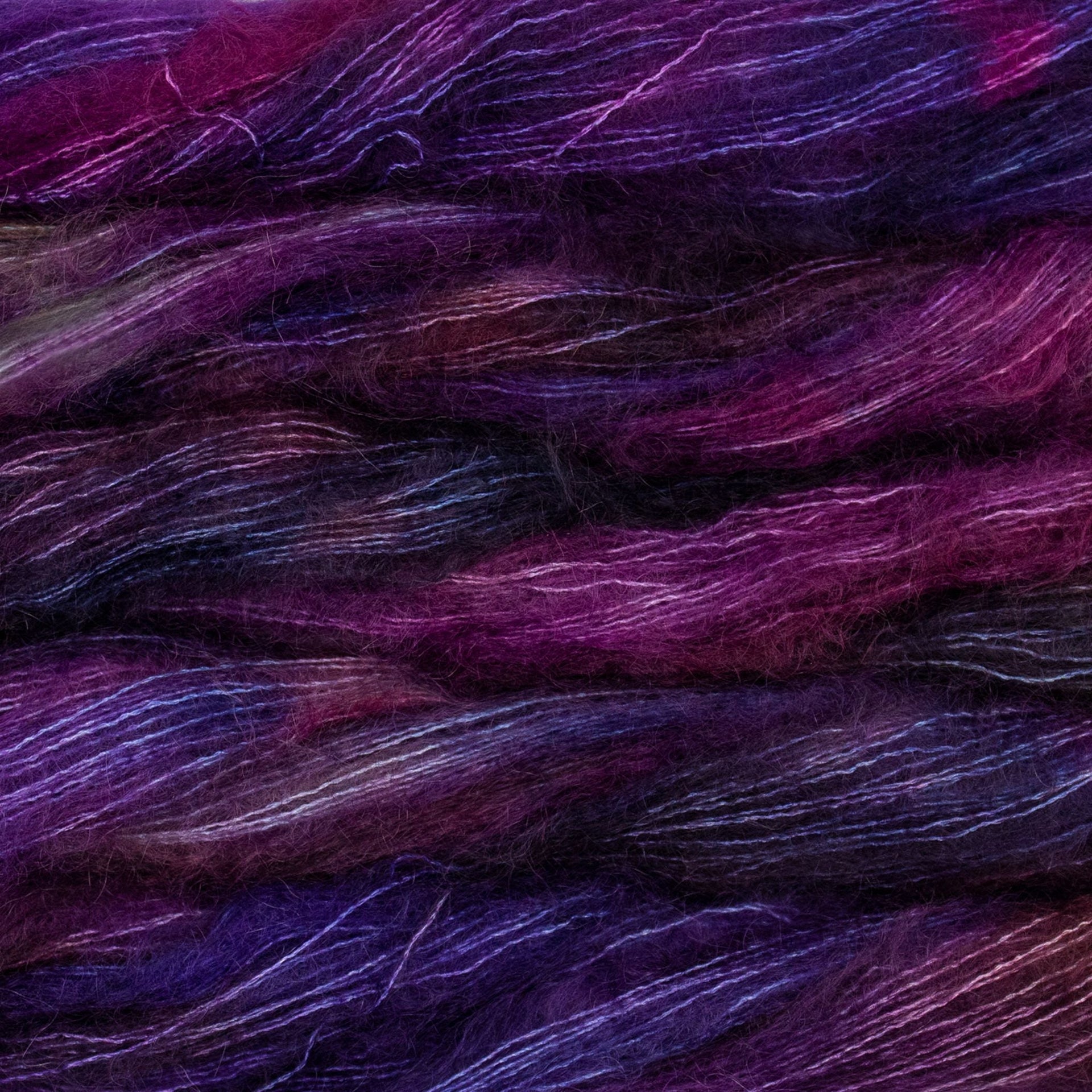 Soft skeins of Malabrigo Mohair yarn in shades of purple, magenta, and navy.