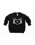 Mama's Boo Skeleton Heart Hands Pullover in black and white with a playful, spooky-cute design.