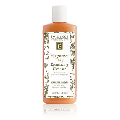 Bright orange bottle of Eminence Mangosteen Daily Resurfacing Cleanser with botanical label