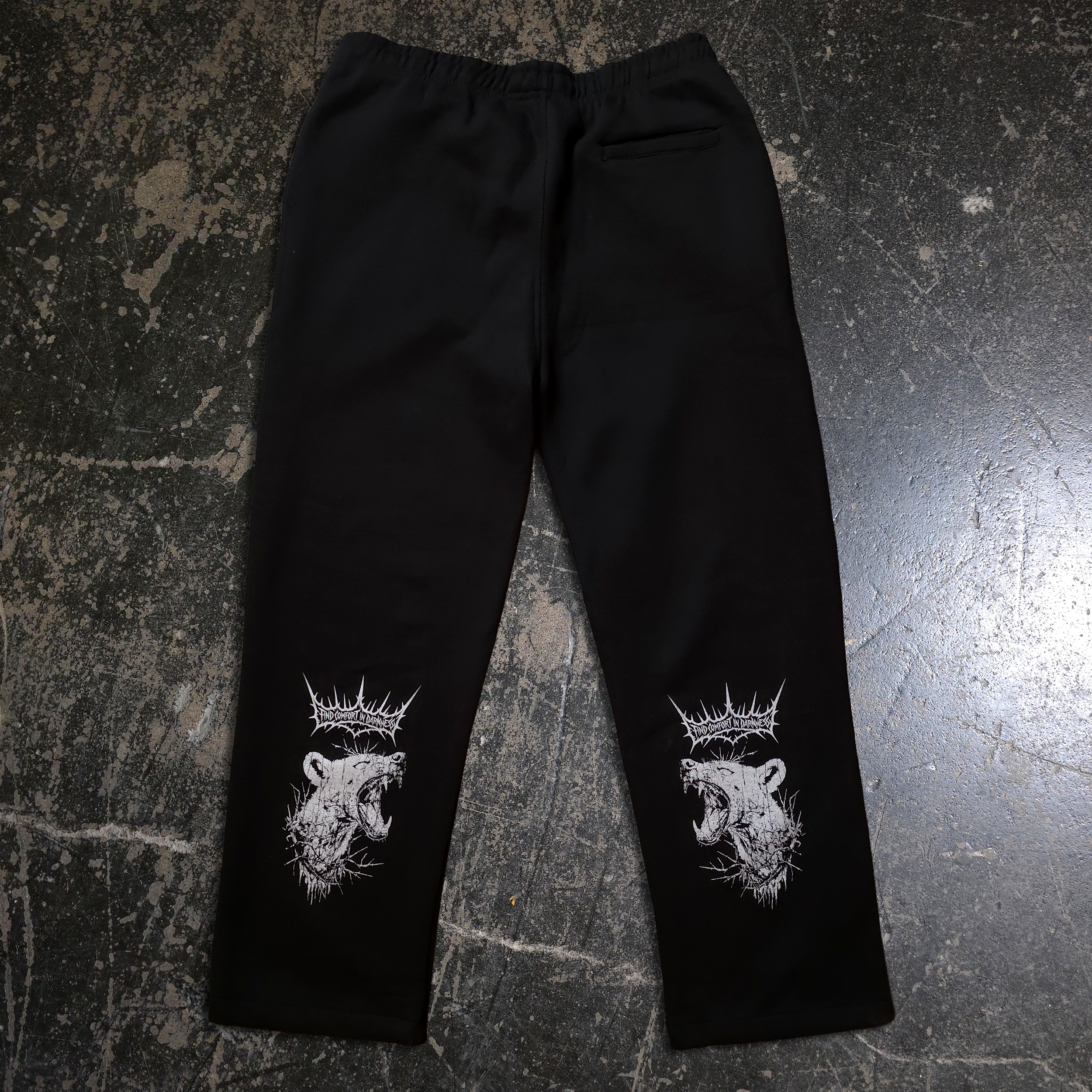 Front and back view of black heavyweight fleece sweatpants featuring bear crown graphic and logo