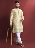 A cream-colored jacquard silk kurta featuring intricate traditional Amboj work.