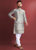 Men wearing a grey Jacquard silk kurta featuring detailed Amboj embroidery work