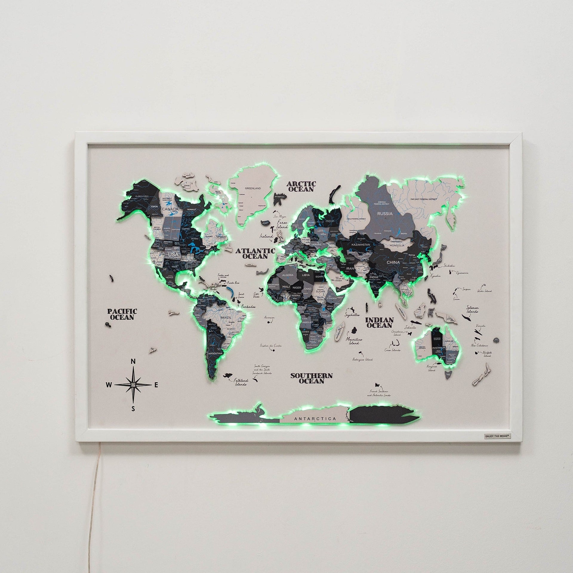 Minimalist wooden world map on a cork board with integrated LED lights