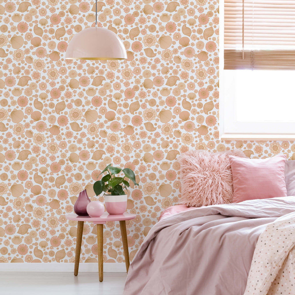 Muriel coastal bohemian wallpaper in peach, tan, and white applied to a bedroom wall.