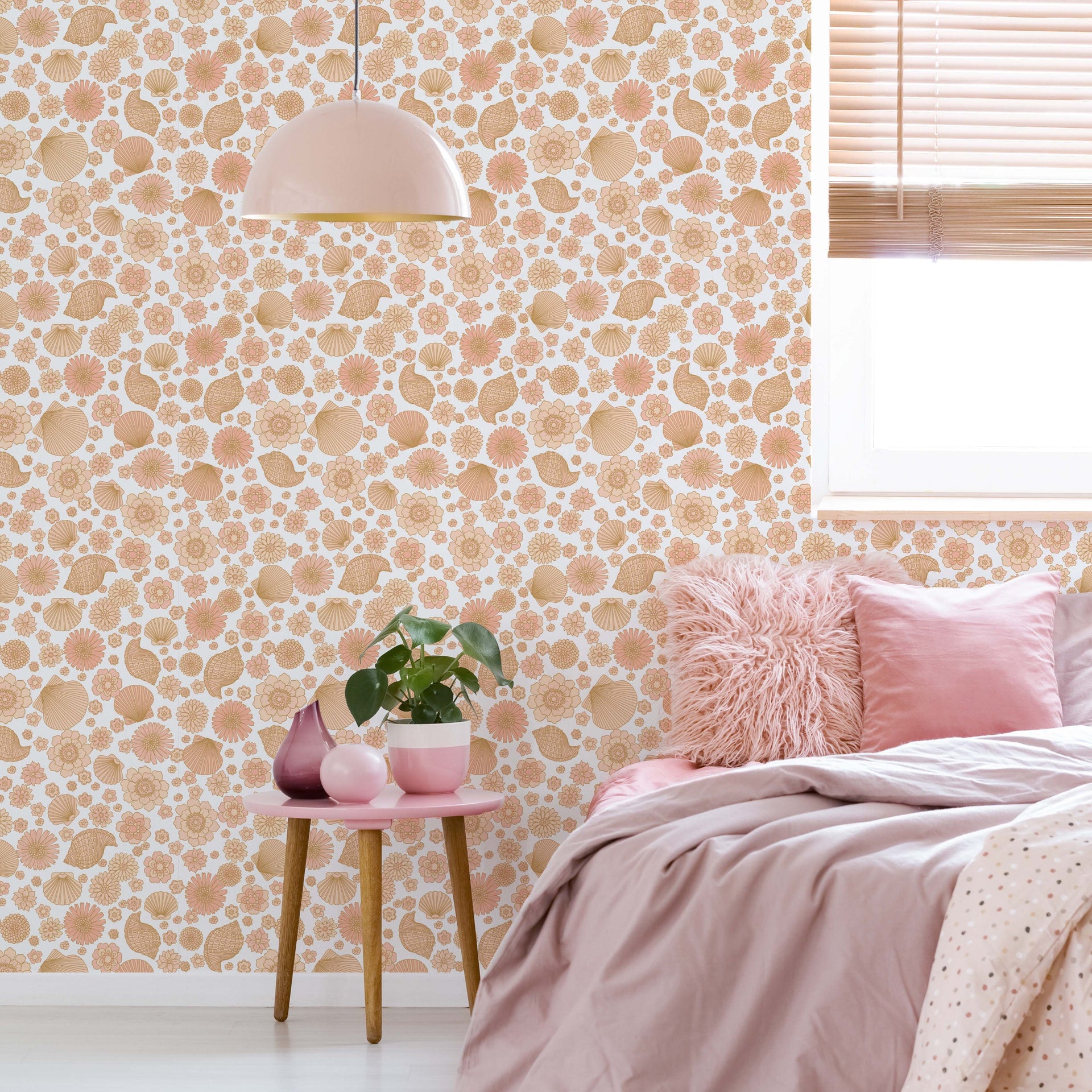 Muriel coastal bohemian wallpaper in peach, tan, and white applied to a bedroom wall.