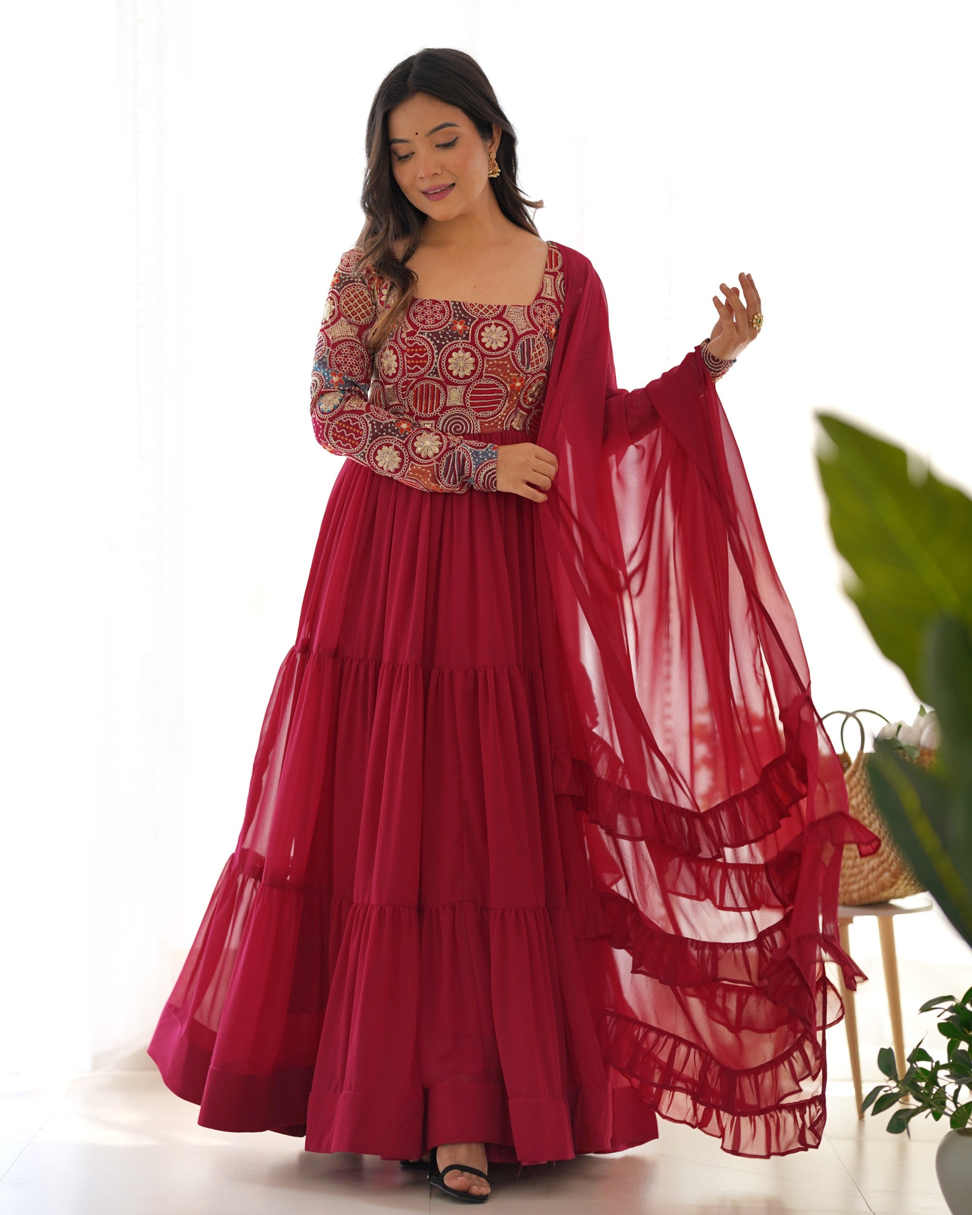 Front view of a maroon faux georgette Anarkali suit with heavy 9-needle thread embroidery and full flare.