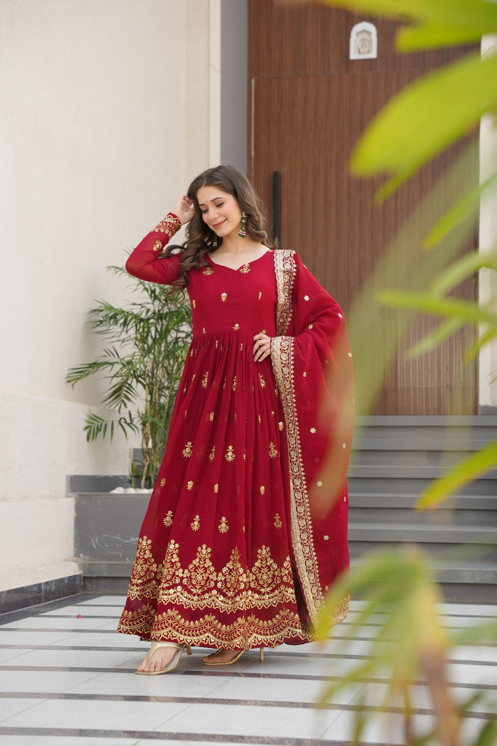 Maroon faux georgette Anarkali gown with rich gold Zari and sequins embroidery detail