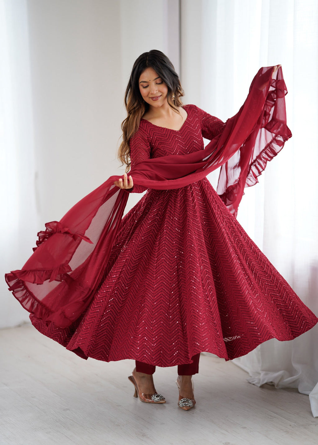 A maroon heavy fox georgette Anarkali kurta set with intricate Lucknowi sequence work and a voluminous 4-meter flair.