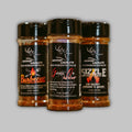 Three jars of Nose Down Seasonings in black, brown, and orange labels, styled for a rustic kitchen aesthetic.