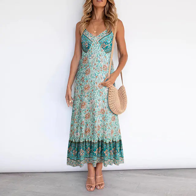 A woman wearing a sleeveless floral boho midi dress with spaghetti straps and a v-neckline