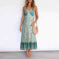 A woman wearing a sleeveless floral boho midi dress with spaghetti straps and a v-neckline