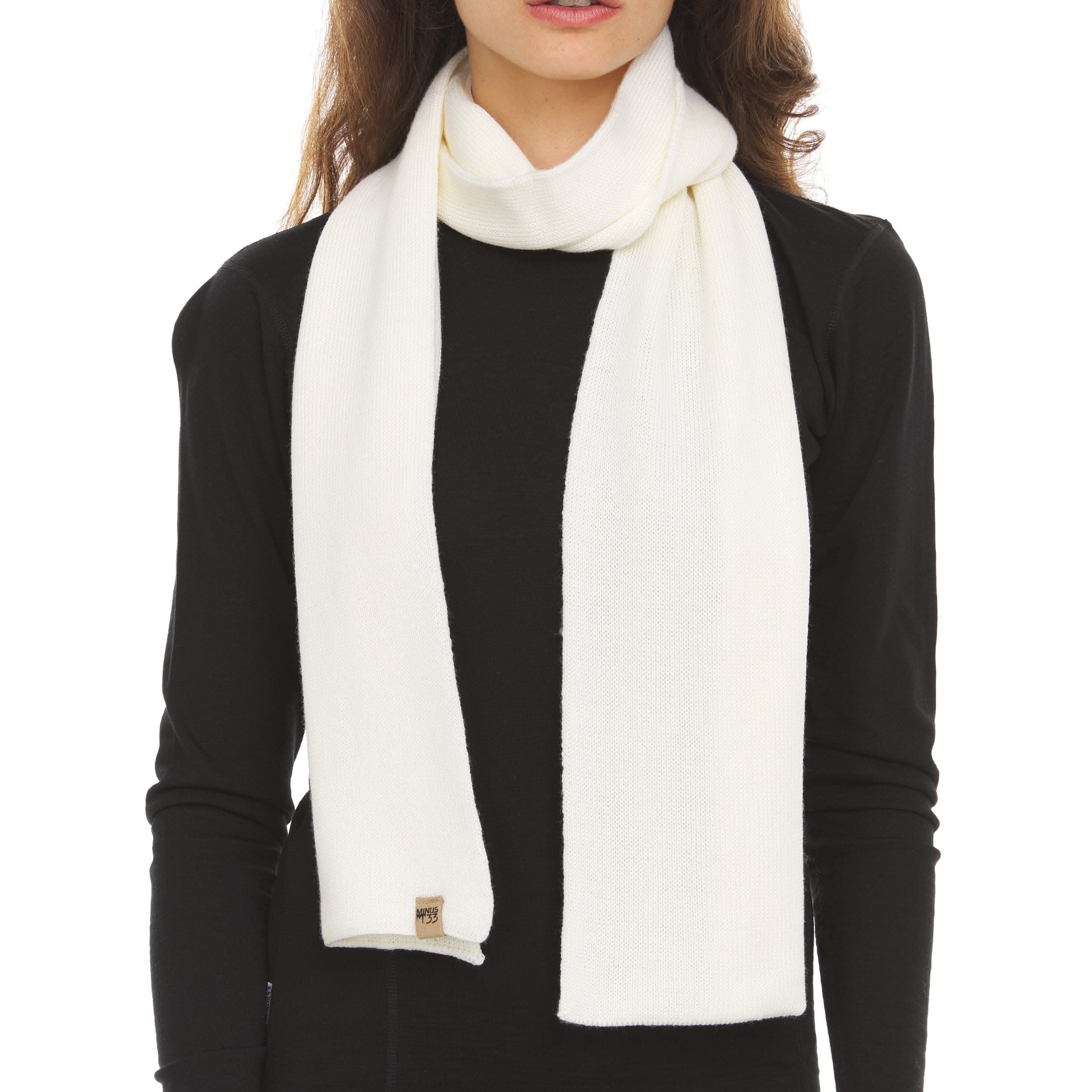 Minimalist 100% Merino wool knit scarf in solid black or white, suitable for both casual and formal wear.