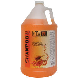 A gallon container of MODA Honey Almond Shampoo with Fision AquaShield technology.
