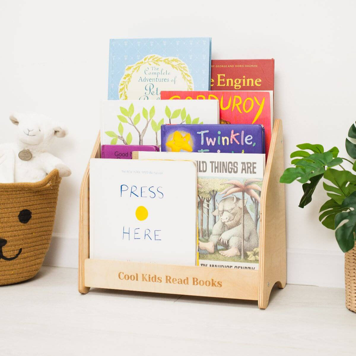 Minimalist Montessori bookshelf for toddlers in natural wood and dark green finishes.