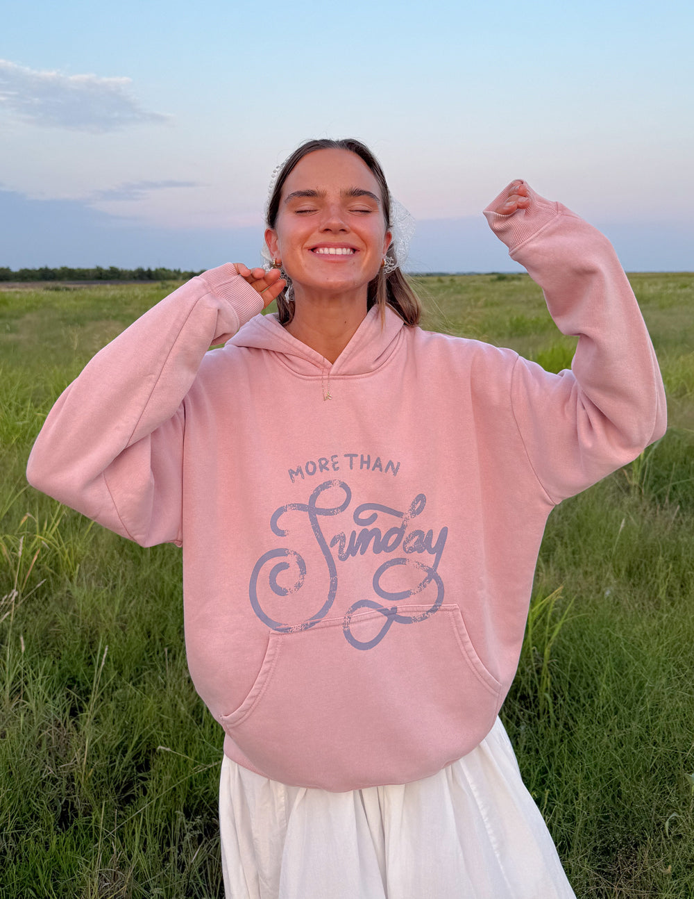Unisex cotton hoodie in dusty pink and muted blue featuring More Than Sunday branding
