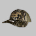 Back Pack Bow Hunter Richardson 112 Trucker hat in a forest hunting setting