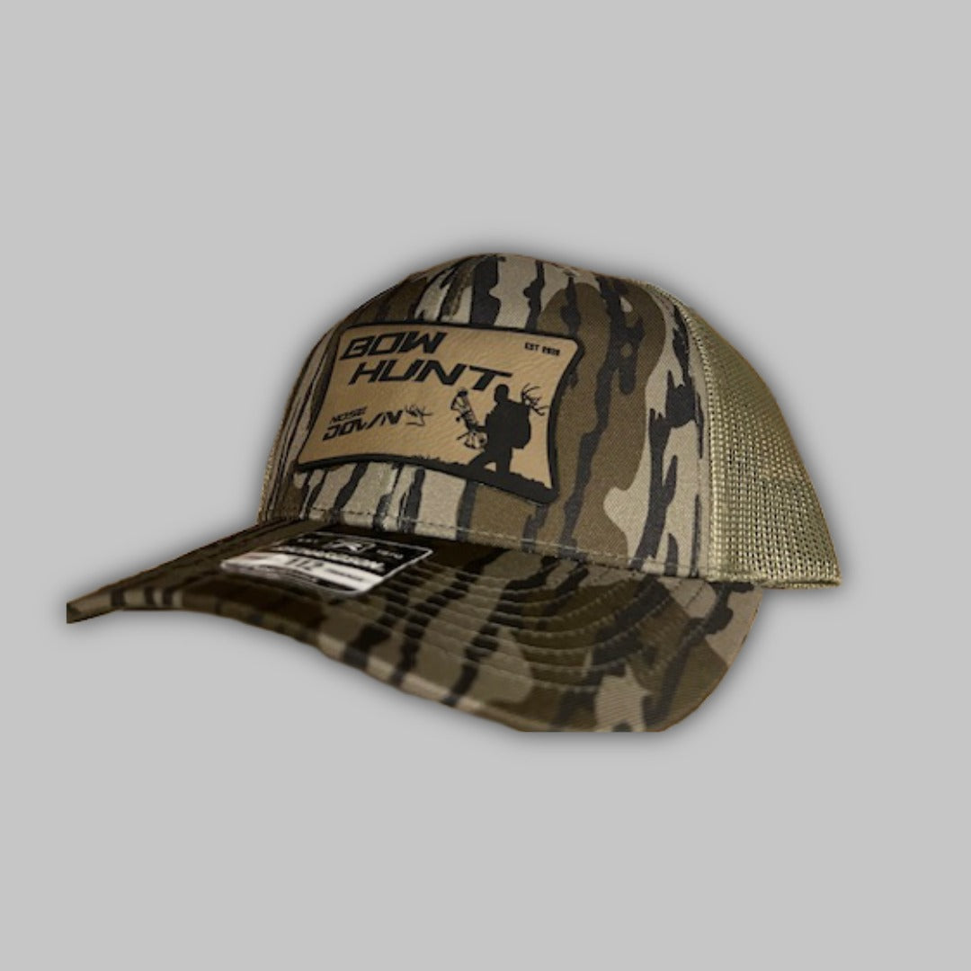 Back Pack Bow Hunter Richardson 112 Trucker hat in a forest hunting setting