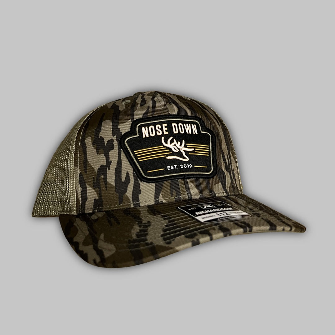 Vintage black trucker hat with a premium woven logo patch.