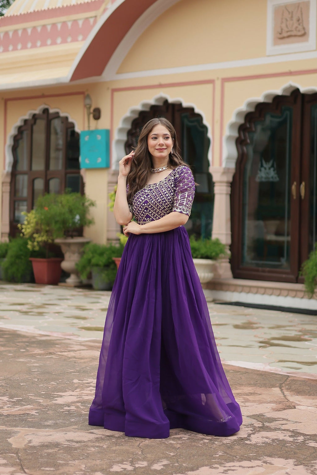 Stunning purple georgette evening gown with intricate sequence embroidery.