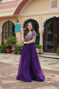 Stunning purple georgette evening gown with intricate sequence embroidery.