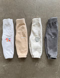 A pair of comfortable, oversized kids sweatpants in a mystery surprise style
