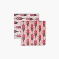 A set of two pink Bahaar cotton table napkins with hand-block printed larkspur floral patterns.