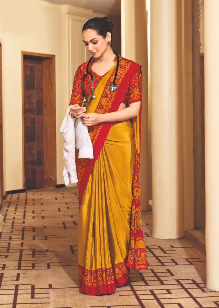Yellow crepe silk saree featuring traditional prints for party wear