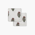 Hand-block printed floral cotton napkins in pink and green on a white base for bohemian dining decor.