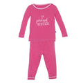 A toddler long sleeve two-piece pajama set in Winter Rose pink with a Proud Sister graphic on the front.