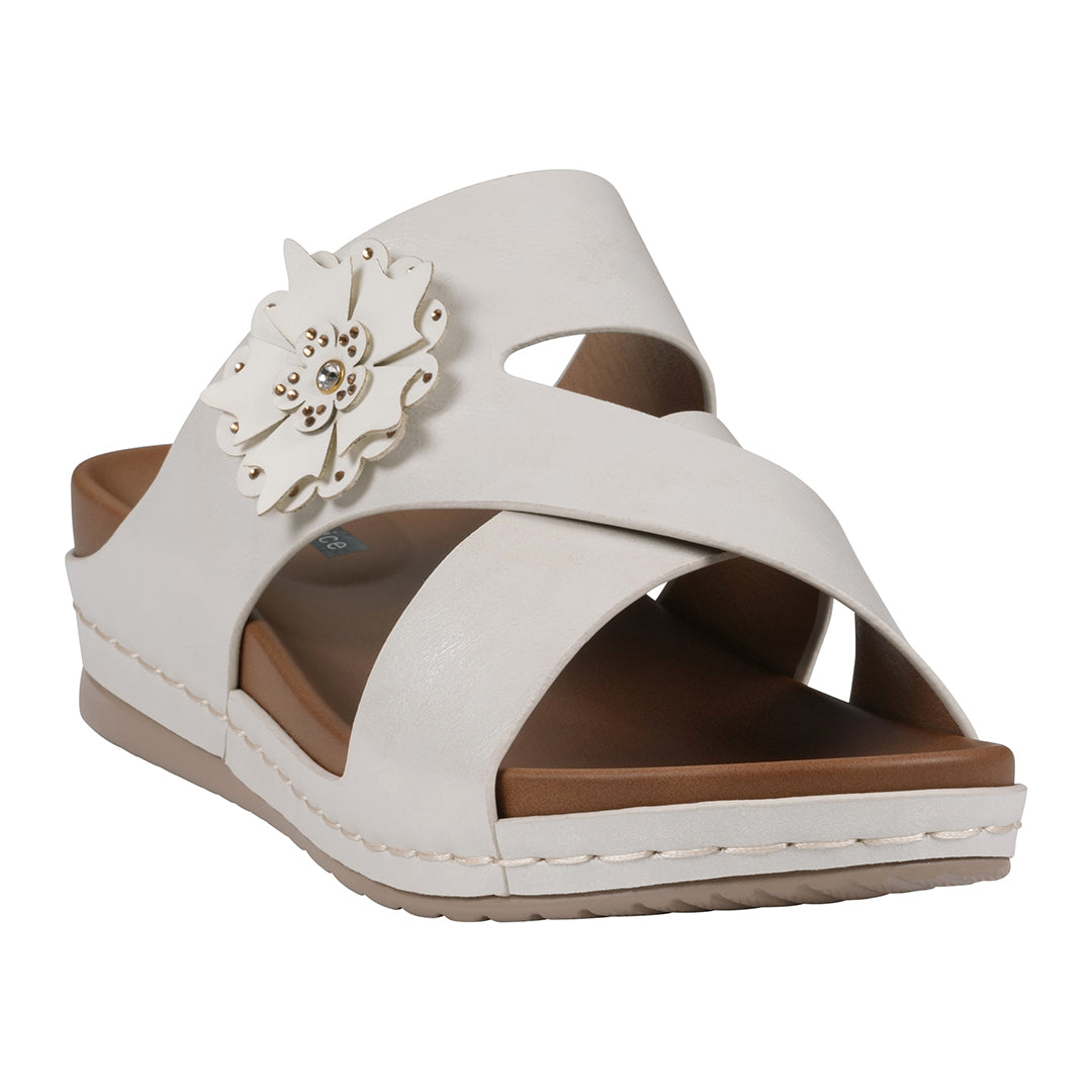 Women's white slip-on comfort sandals featuring a crisscross strap design and a decorative white flower accent.