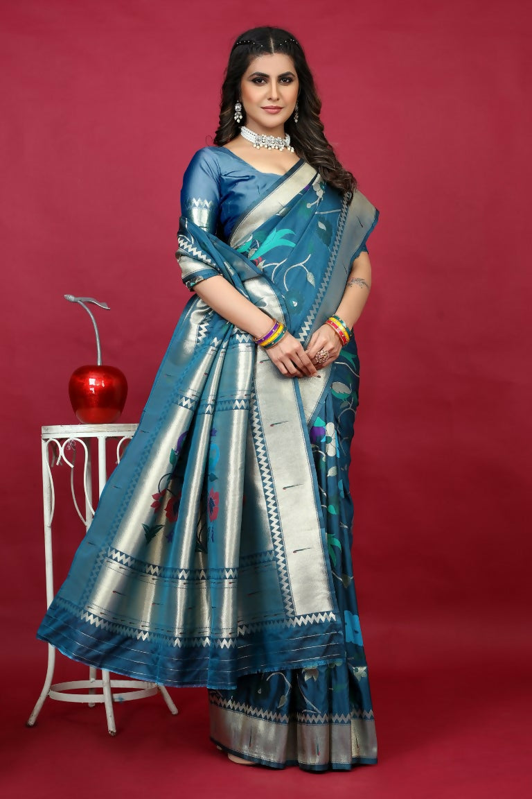 Teal silk saree with silver Zari woven floral patterns and matching teal blouse