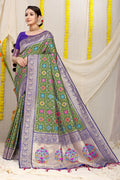 Green Patola silk saree with zari woven accents and blue contrast blouse