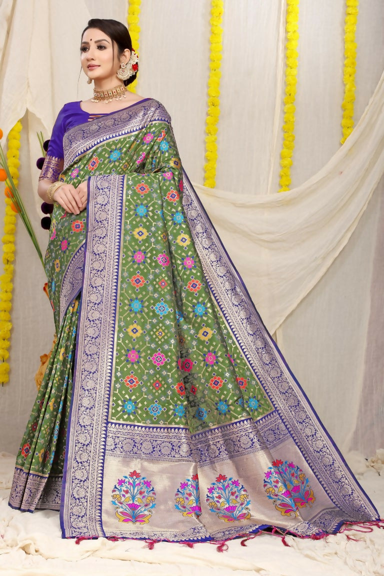 Green Patola silk saree with zari woven accents and blue contrast blouse