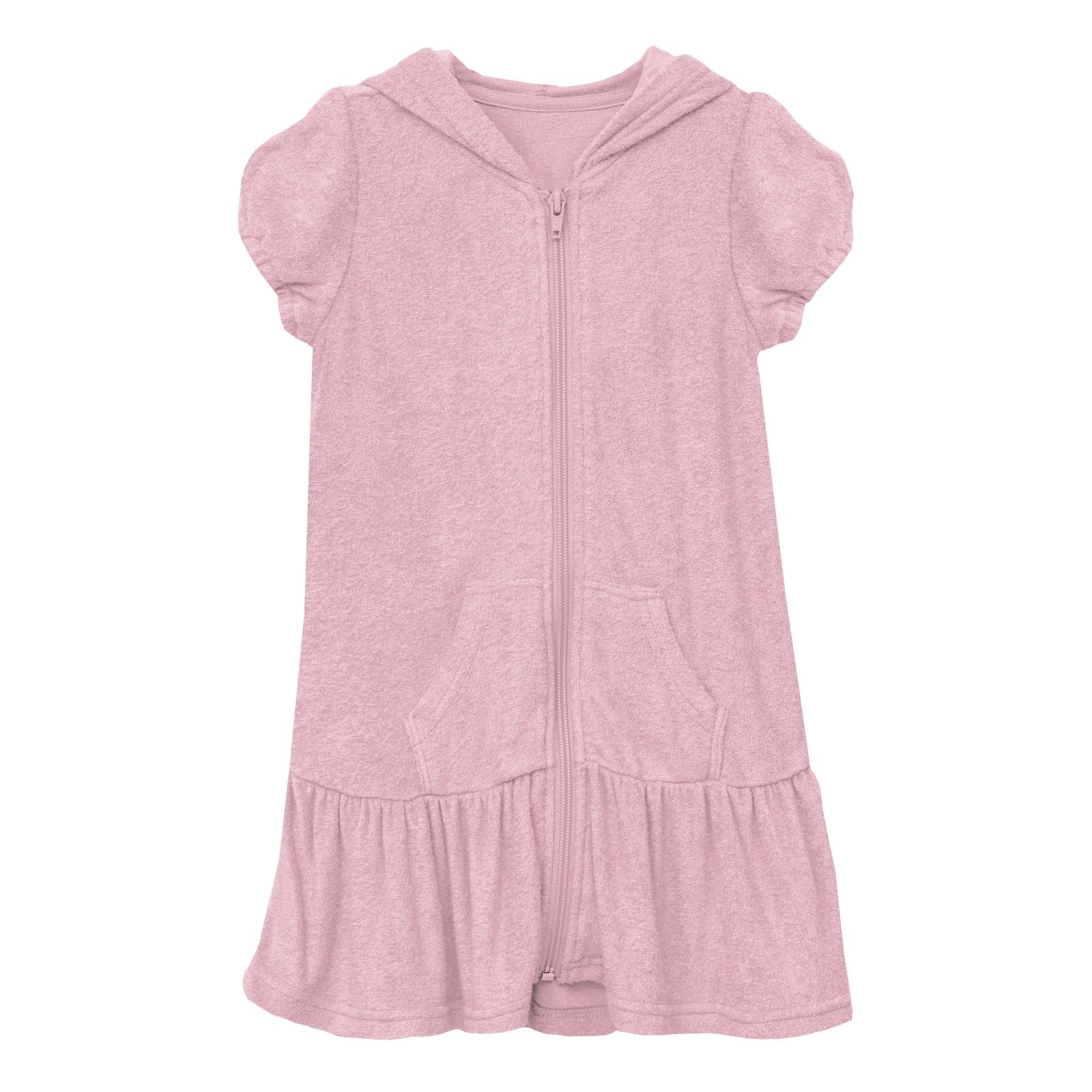 Little girl wearing a dusty lilac terry cloth ruffle swim cover-up in Cake Pop color.