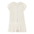 Close up of the texture of a natural beige cotton terry ruffle swim cover-up