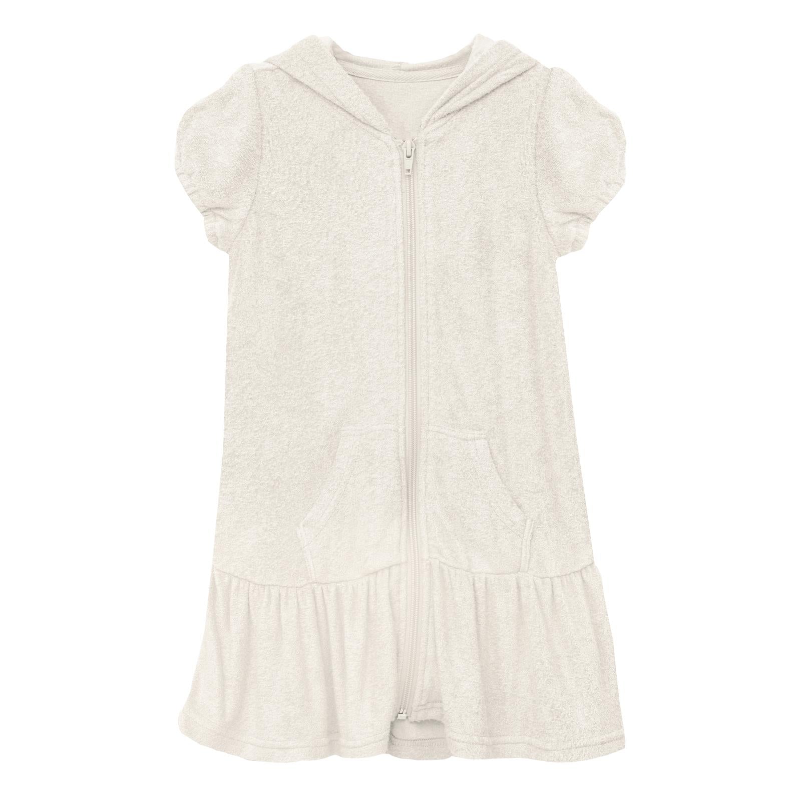 Close up of the texture of a natural beige cotton terry ruffle swim cover-up