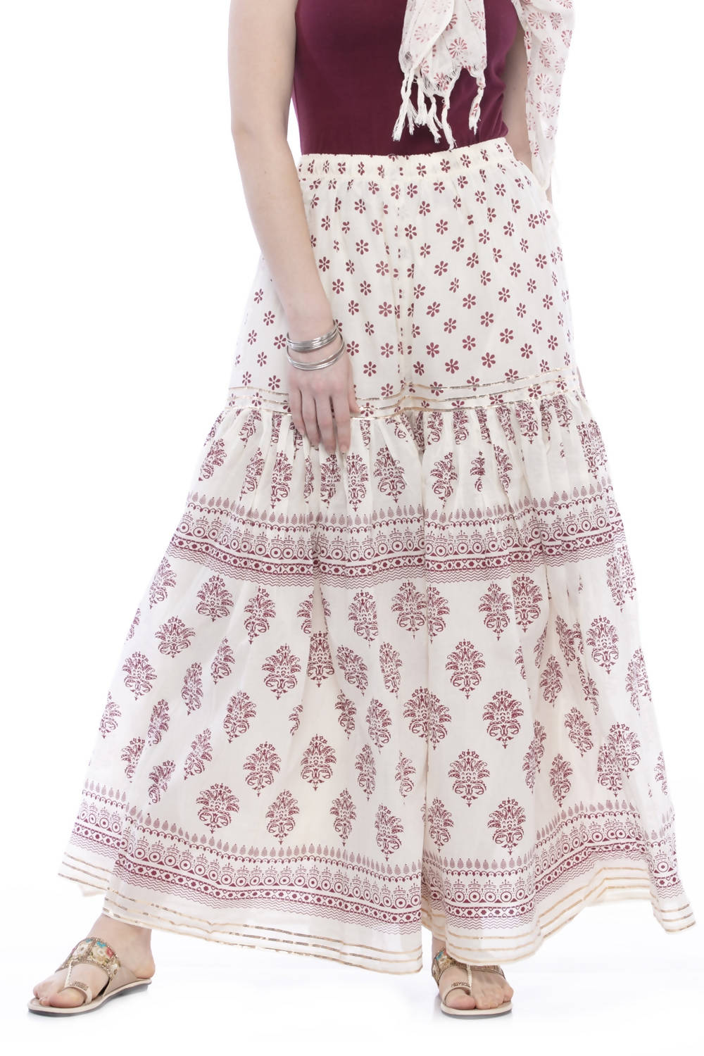 Off-white and magenta cotton block print palazzo pants with detailed lace work trim.