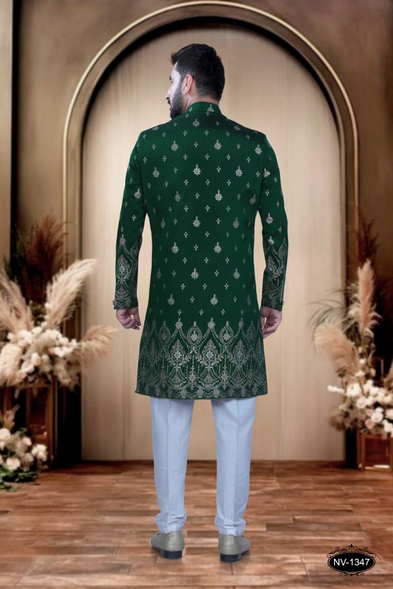 A young boy wearing a green silk Indo-Western kurta with a designer foil print panel and white polo pyjamas.