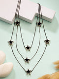 Black star-shaped layered fashion necklace with multiple pendants for a celestial look