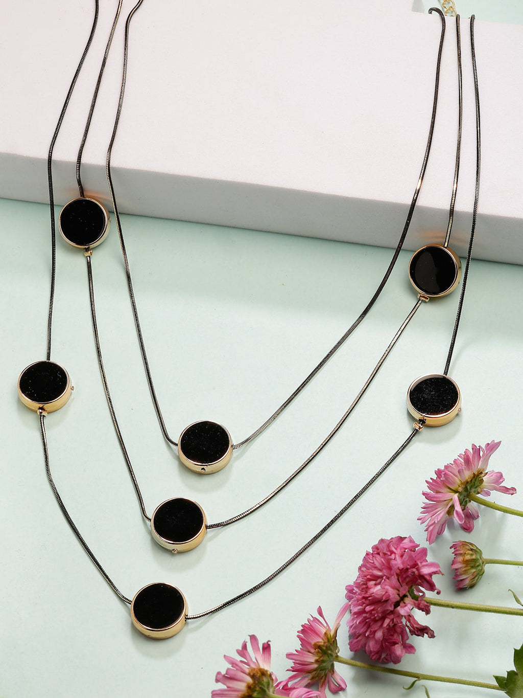 Modern black layered necklace with circular pendants styled for a chic look