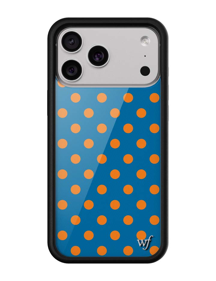 A sleek iPhone case with a deep blue background and bright orange polka dots, featuring a black rubber protective bumper.