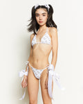 Close up of The Purrrfect Bikini Top featuring a Siamese cat illustrative print, halter neck, and golden heart charm.
