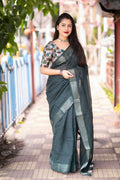 Green linen saree with self-weaving checks and golden pattu border